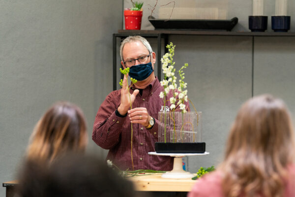 teacher demonstrating a technique during a floral arts class