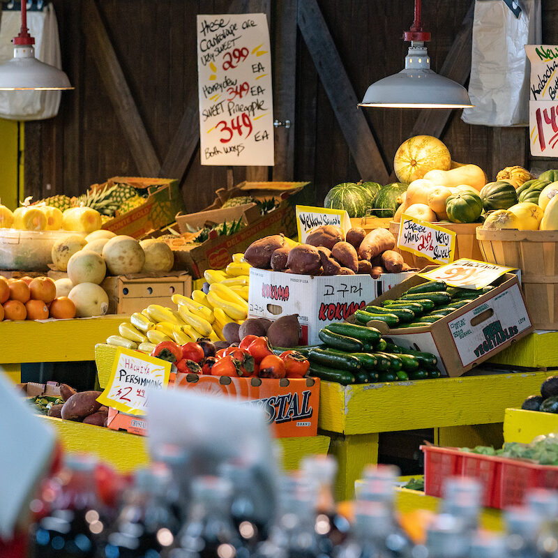 various fruits and vegetables on display in a store